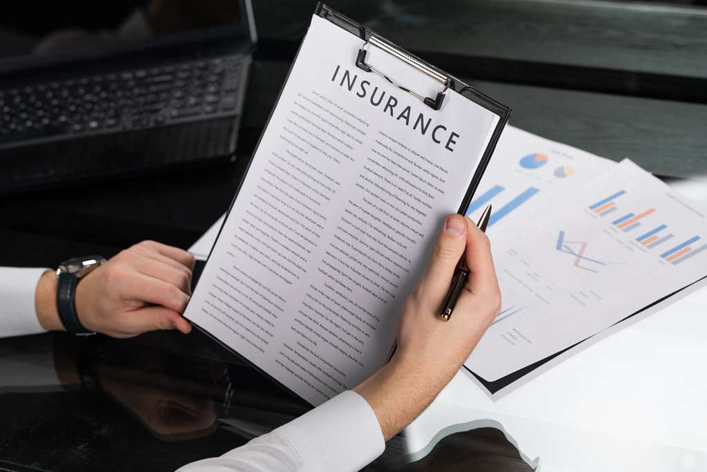 A man looking at insurance documents