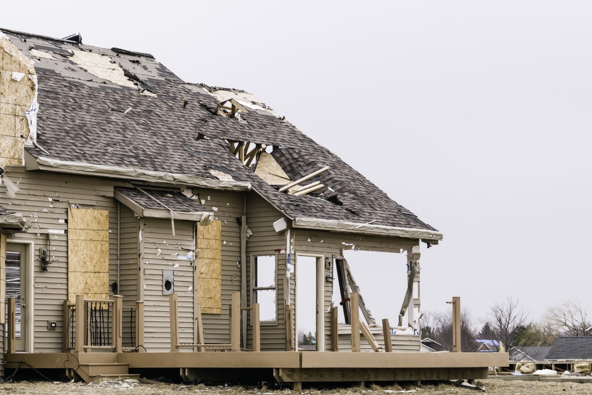 Damaged house structure after being hit by a tornado