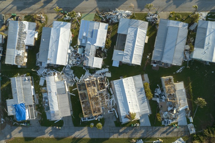 Aerial view of roofs and houses damaged by wind