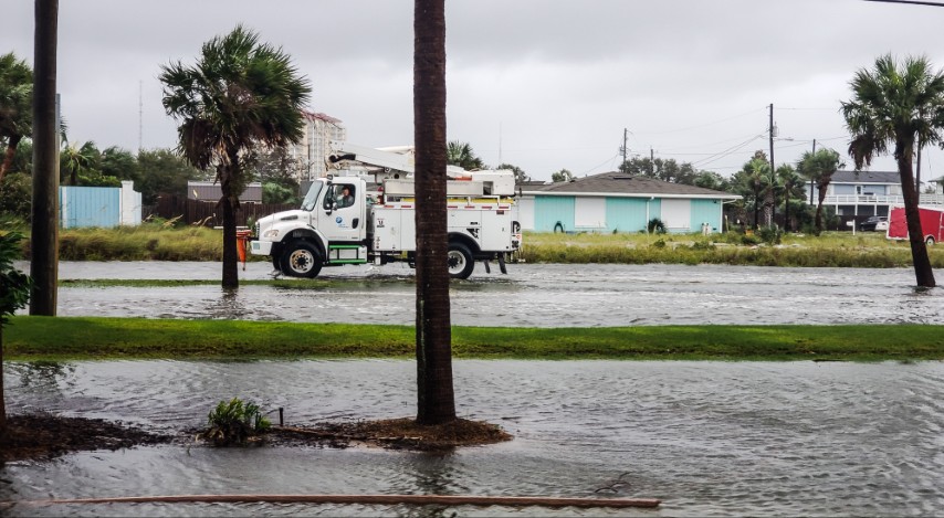A truck driving on the road after a hurricane hit