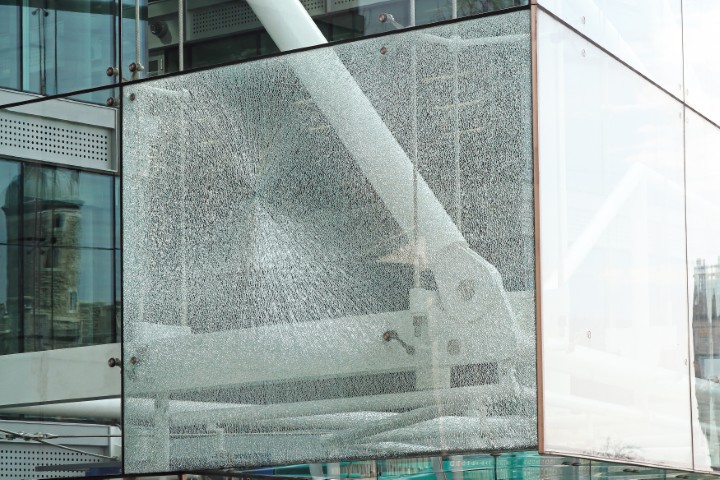 Damaged glass at the corner of a building