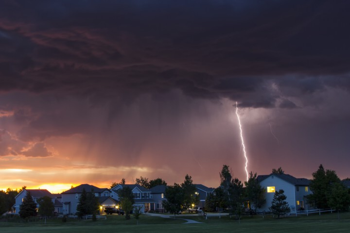 Lightning striking near some houses