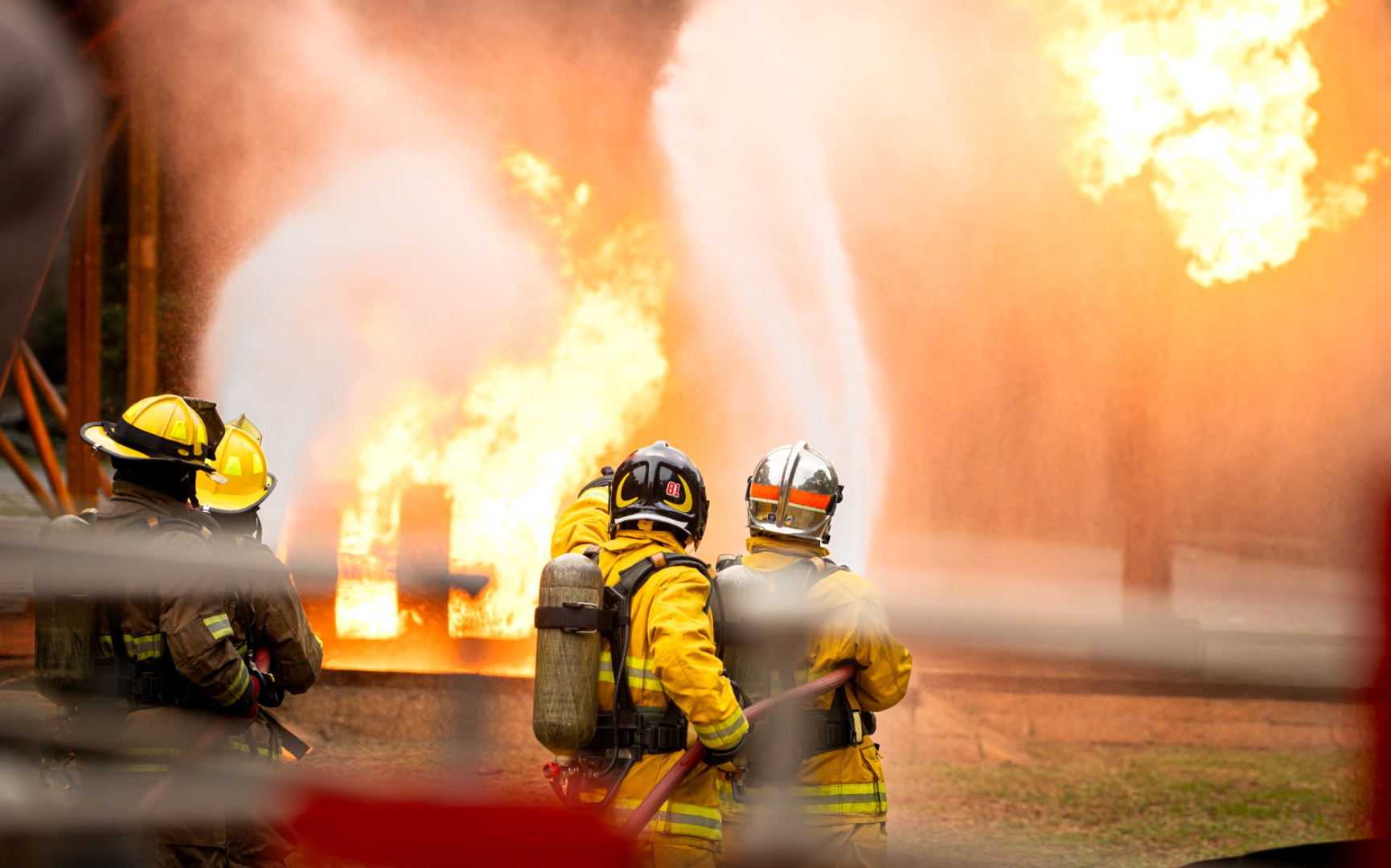 Firefighters spraying water on a fire