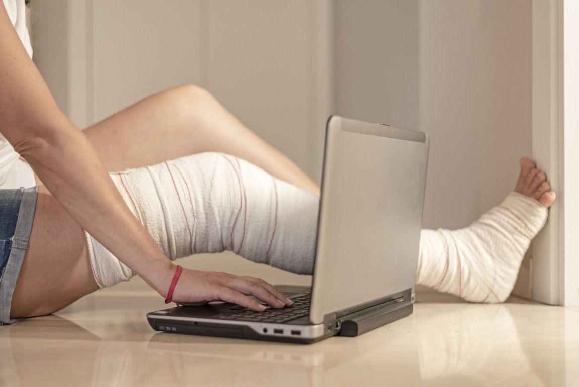 An injured person using a laptop